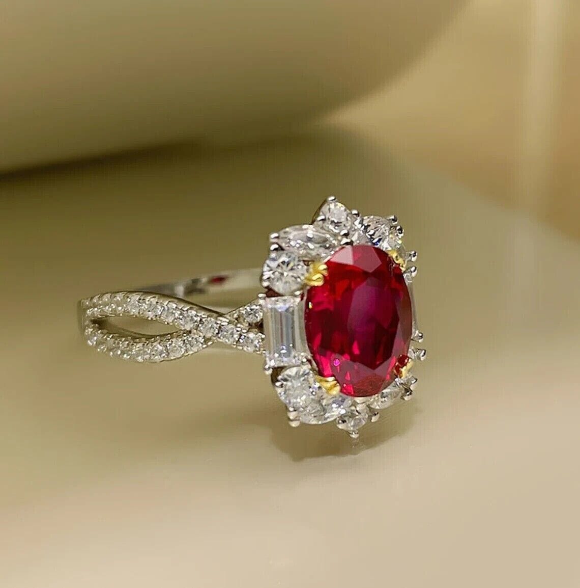 Luxurious oval-cut red ruby engagement ring, beautifully displayed in a velvet gift box